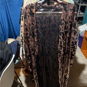 Black/goldish cover. Perfect for a cover for a dress. No size listed fits 0x/1x